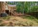 Large backyard with deck and stairs overlooking the yard, with picnic table at 4128 Mayflower Sw Ct, Lilburn, GA 30047