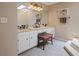 Bright bathroom featuring double sinks, a vanity area, and a well-lit mirror at 4128 Mayflower Sw Ct, Lilburn, GA 30047