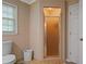 Bathroom featuring a toilet, tiled walk-in shower, and tile flooring at 4128 Mayflower Sw Ct, Lilburn, GA 30047