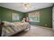 Bedroom with green walls, ceiling fan and carpet flooring at 4128 Mayflower Sw Ct, Lilburn, GA 30047