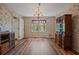 Dining room with floral wallpaper, hardwood floors, chandelier, and window views at 4128 Mayflower Sw Ct, Lilburn, GA 30047