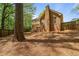 Back of brick house with a two-level deck and a spacious yard with mature trees and wooden privacy fence at 4128 Mayflower Sw Ct, Lilburn, GA 30047
