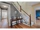 Hallway area featuring hardwood flooring, stairs, and wall decor at 4128 Mayflower Sw Ct, Lilburn, GA 30047