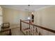 Hallway with wood handrail and staircase, and natural light at 4128 Mayflower Sw Ct, Lilburn, GA 30047