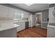 A well-lit kitchen features white cabinets and countertops and stainless steel appliances at 4128 Mayflower Sw Ct, Lilburn, GA 30047