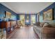 Traditional living room with blue walls, hardwood flooring, and seating area at 4128 Mayflower Sw Ct, Lilburn, GA 30047