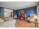 Traditional living room with blue walls, hardwood flooring, and seating area at 4128 Mayflower Sw Ct, Lilburn, GA 30047