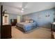 Spacious main bedroom with light blue walls, fan and carpet flooring at 4128 Mayflower Sw Ct, Lilburn, GA 30047