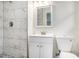 Modern bathroom featuring marble tile in the shower, a new vanity and a sleek design, offering a spa-like experience at 1548 Highway 81 W, Mcdonough, GA 30253