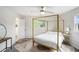 Bedroom with gold-colored four poster bed, side tables and neutral decor at 1548 Highway 81 W, Mcdonough, GA 30253
