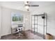 Bright bedroom with a large window, modern ceiling fan and space for a work-from-home setup at 1548 Highway 81 W, Mcdonough, GA 30253