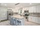 Bright and airy kitchen with stainless steel appliances, granite counters, white cabinetry, and a stylish lighting fixture at 1548 Highway 81 W, Mcdonough, GA 30253