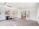 Sunlit living room with a desk area and french doors leading to another room at 1548 Highway 81 W, Mcdonough, GA 30253