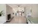 Spacious living area connected to a modern kitchen, featuring stylish flooring and a charming brick fireplace at 1548 Highway 81 W, Mcdonough, GA 30253