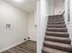 Stairway featuring carpeted steps, white trim and nearby laundry hookups on a laminate floor at 1548 Highway 81 W, Mcdonough, GA 30253