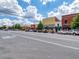 Street view of city, showing storefronts and traffic, on a sunny day with scattered clouds at 158 Bluffington Way, Marietta, GA 30066
