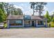 A commercial grey building with blue accents is ready for its new owners in a beautiful, natural setting at 1800 Jordan Brook Dr, Lawrenceville, GA 30043