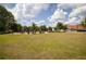 A well maintained green space with lush lawn, mature trees and neighborhood amenities under sunny skies at 1800 Jordan Brook Dr, Lawrenceville, GA 30043