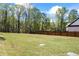 Large grassy area perfect for outdoor activities and privacy, bordered by trees and a privacy fence at 407 Thunder Rd, Buford, GA 30518