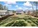 Expansive backyard with lush green lawn, privacy fence, and multiple homes in a beautiful suburban community at 407 Thunder Rd, Buford, GA 30518