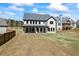 New construction home features a large backyard, patio and lush green lawn at 407 Thunder Rd, Buford, GA 30518