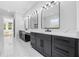 Elegant bathroom features double vanity with black cabinets, white countertops, and modern lighting at 407 Thunder Rd, Buford, GA 30518