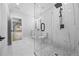 Elegant bathroom featuring a marble shower, glass door and modern fixtures at 407 Thunder Rd, Buford, GA 30518