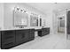 Elegant bathroom featuring dual vanities, framed mirrors, and contrasting cabinets for a modern look at 407 Thunder Rd, Buford, GA 30518