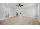 Light-filled bedroom with hardwood floors, ceiling fan, and walk-in closet at 407 Thunder Rd, Buford, GA 30518