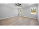 Bright bedroom with hardwood floors, neutral walls, and natural light from windows at 407 Thunder Rd, Buford, GA 30518