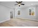 Light-filled bedroom with hardwood flooring and access to a walk-in closet at 407 Thunder Rd, Buford, GA 30518