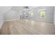 Bright bonus room with multiple windows and hardwood flooring at 407 Thunder Rd, Buford, GA 30518