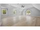 Spacious bonus room features natural light, wood floors, and a ceiling fan at 407 Thunder Rd, Buford, GA 30518