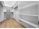 Large walk-in closet with custom shelves and hardwood flooring at 407 Thunder Rd, Buford, GA 30518