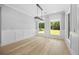 Open dining room with modern chandelier, hardwood floors, and natural light at 407 Thunder Rd, Buford, GA 30518