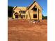 Exterior view of new home under construction showcasing framing, windows, and ladder at 407 Thunder Rd, Buford, GA 30518