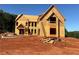 Exterior view of new home under construction showcasing framing, windows, and ladder at 407 Thunder Rd, Buford, GA 30518