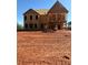 Exterior view of new home under construction with garage and balcony framing at 407 Thunder Rd, Buford, GA 30518