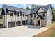 Striking new traditional home with a three-car garage and a welcoming front entrance at 407 Thunder Rd, Buford, GA 30518