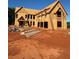 Exterior view of new home under construction showcasing framing, windows, and ladder at 407 Thunder Rd, Buford, GA 30518