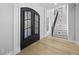 Grand foyer with a staircase, hardwood floors, a large front door, and lots of natural light at 407 Thunder Rd, Buford, GA 30518