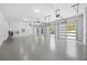 A well-lit three car garage with epoxy flooring and glass panel doors at 407 Thunder Rd, Buford, GA 30518