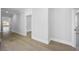 Bright hallway featuring hardwood floors and neutral paint, leading to multiple rooms at 407 Thunder Rd, Buford, GA 30518
