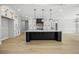 Modern kitchen boasts a large island, stainless steel appliances, and ample counter space at 407 Thunder Rd, Buford, GA 30518