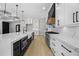 Modern kitchen featuring a large island with marble countertops and stainless steel appliances at 407 Thunder Rd, Buford, GA 30518