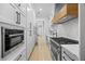 Modern kitchen with white cabinets, stainless steel appliances, and wood accents at 407 Thunder Rd, Buford, GA 30518