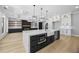 Spacious kitchen with marble island, fireplace, and ample cabinet space for storage at 407 Thunder Rd, Buford, GA 30518