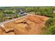 Cleared land for building a new home, near an existing luxury home with a pool, offering great neighborhood amenities at 407 Thunder Rd, Buford, GA 30518