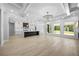 Open-concept living area featuring an island kitchen, lots of windows, and wood floors at 407 Thunder Rd, Buford, GA 30518