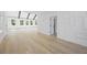 Bright living room boasts hardwood floors, decorative wainscoting, and natural light at 407 Thunder Rd, Buford, GA 30518